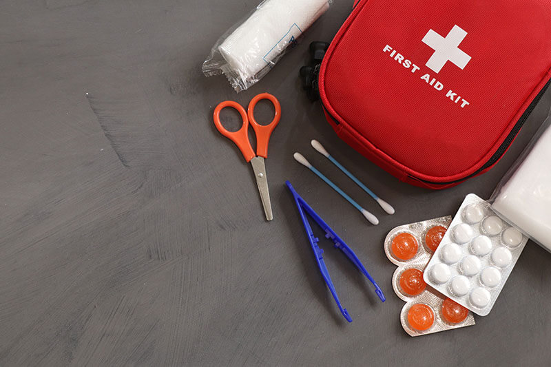 Top view of first aid equipment spread across a concrete surface